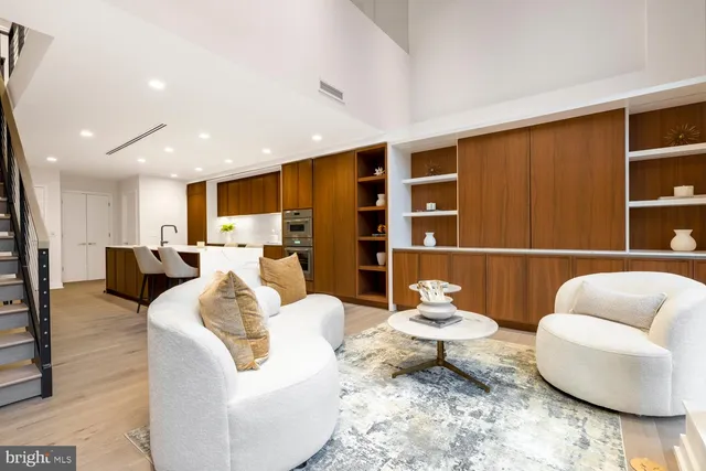 a living room with furniture rug and wooden floor