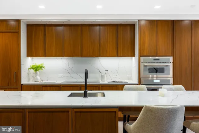 a kitchen with a sink cabinets and a window