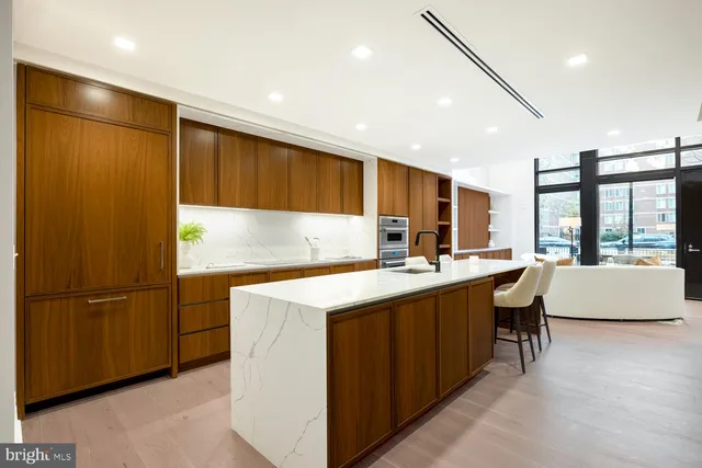 a living room with furniture a piano and wooden floor