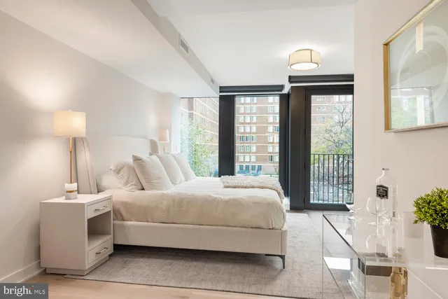 a bedroom with a large bed and a window