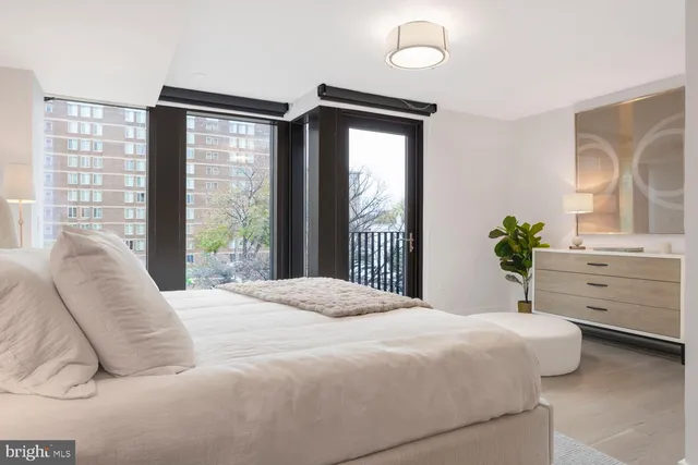 a bedroom with a large bed and a large window