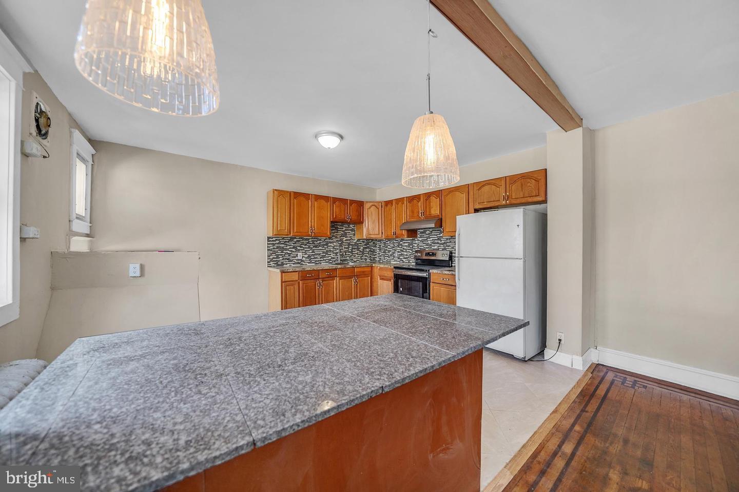 719 North Shedwick Street Philadelphia, PA 19104 - Photo 20 of 24 a kitchen with stainless steel appliances granite countertop a sink and a refrigerator