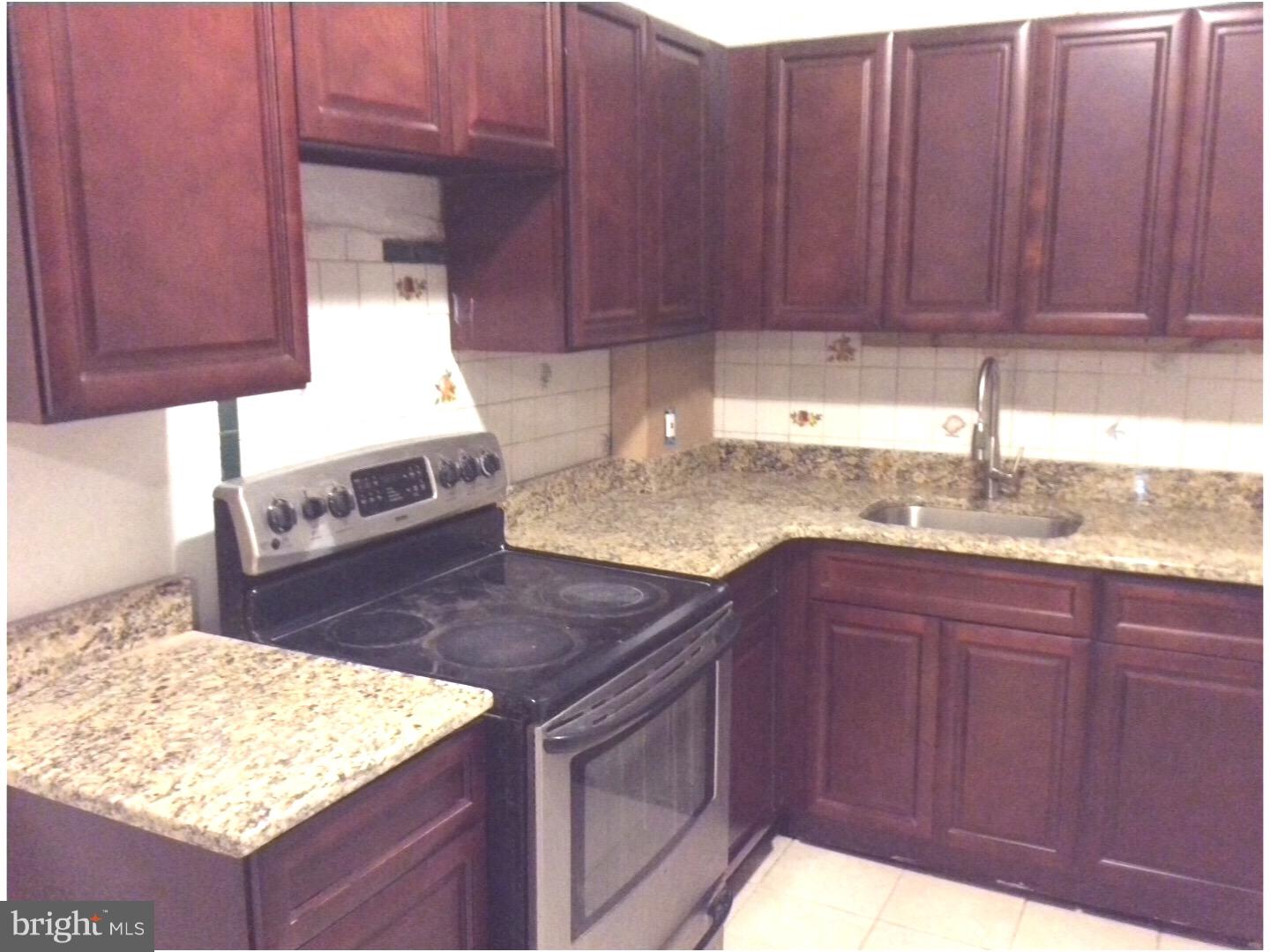 719 North Shedwick Street Philadelphia, PA 19104 - Photo 2 of 24 a kitchen with stainless steel appliances granite countertop wooden cabinets a sink and dishwasher