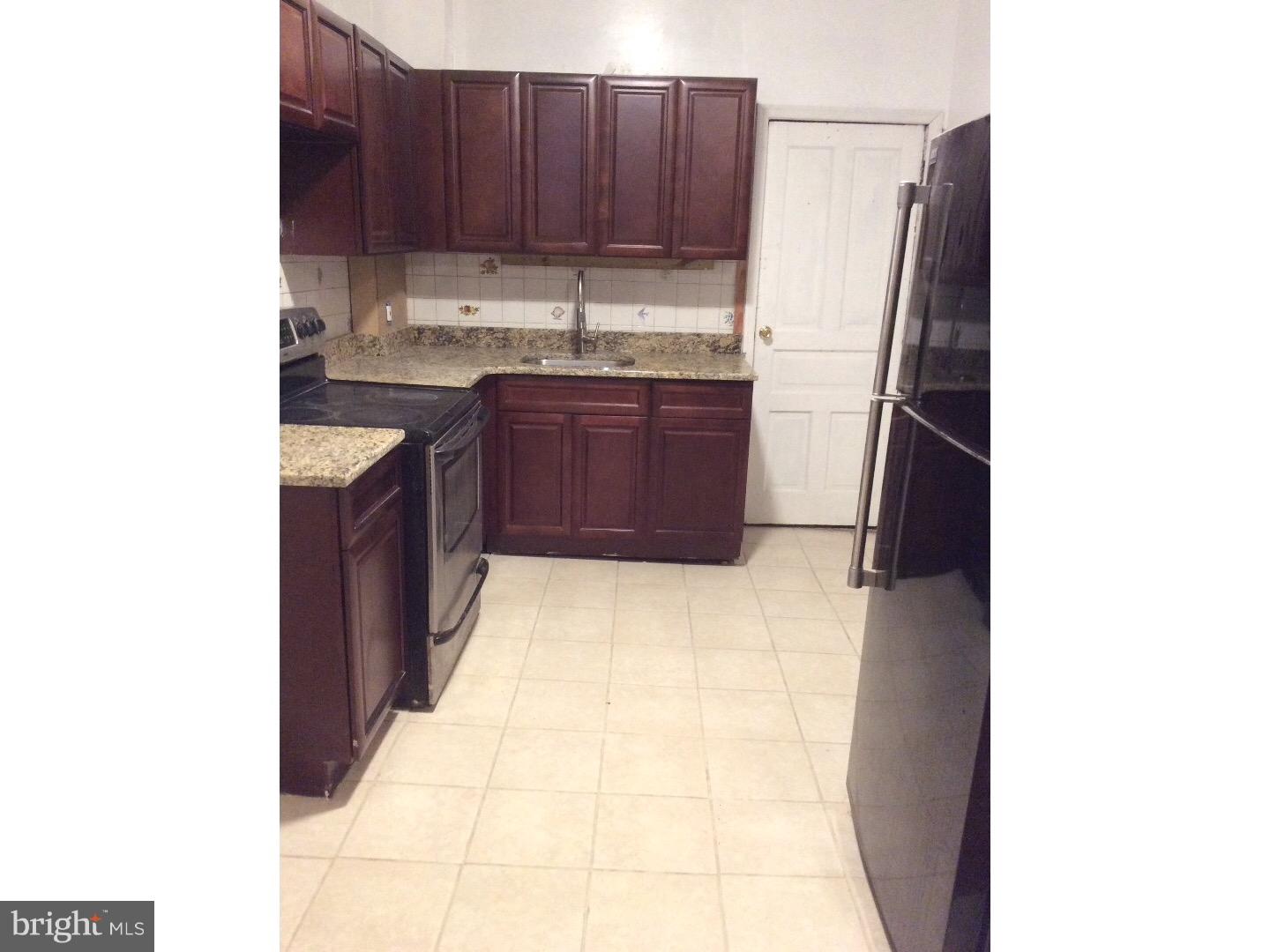 719 North Shedwick Street Philadelphia, PA 19104 - Photo 4 of 24 a kitchen with a sink and cabinets
