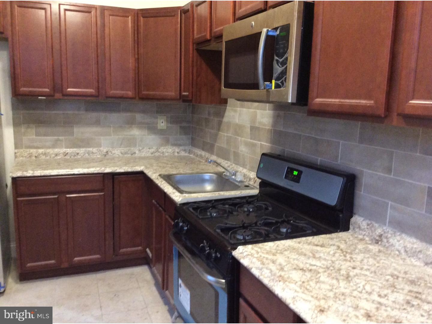 719 North Shedwick Street Philadelphia, PA 19104 - Photo 5 of 24 a kitchen with a stove and a sink