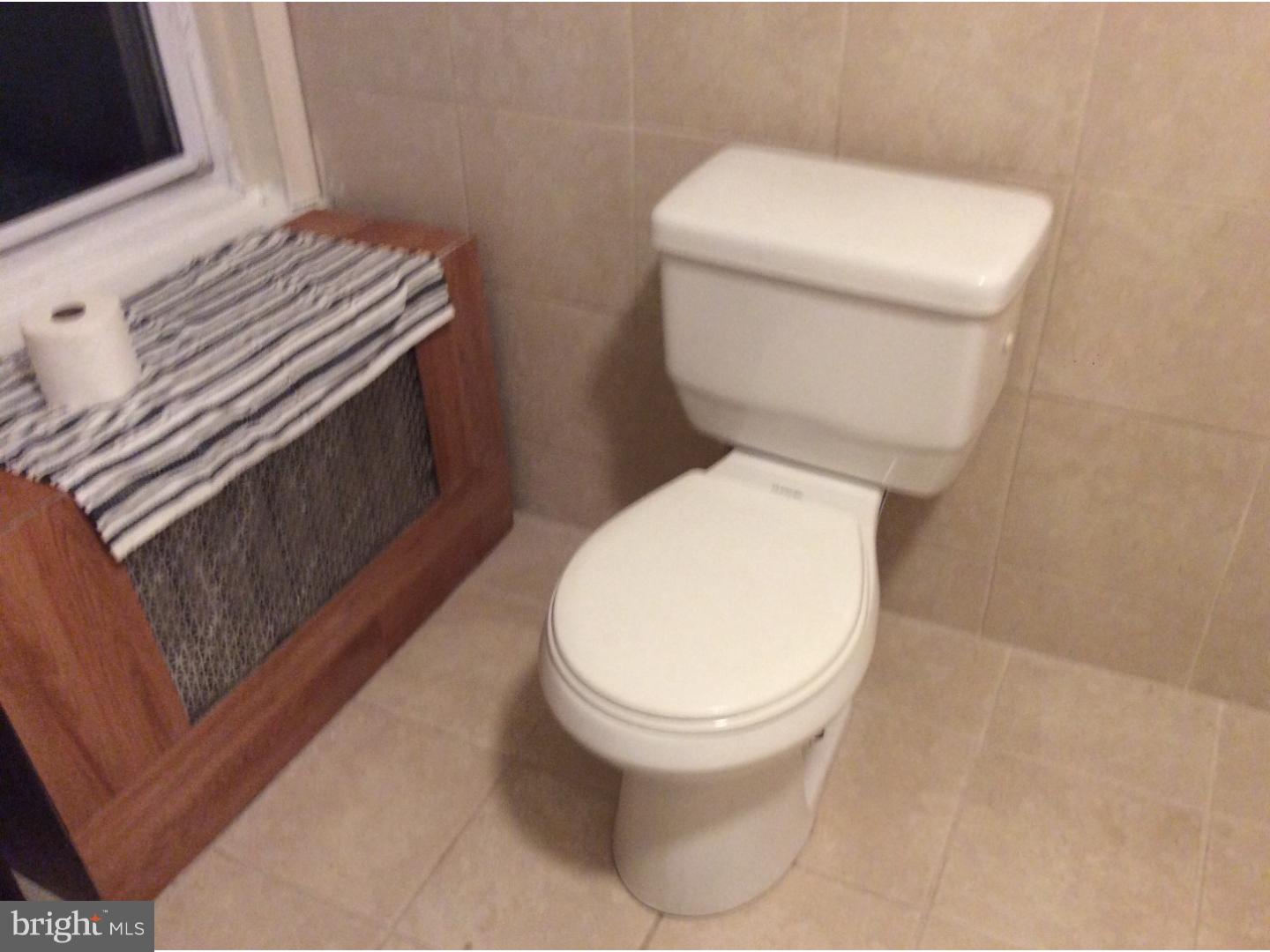 719 North Shedwick Street Philadelphia, PA 19104 - Photo 7 of 24 a bathroom with a toilet and a sink