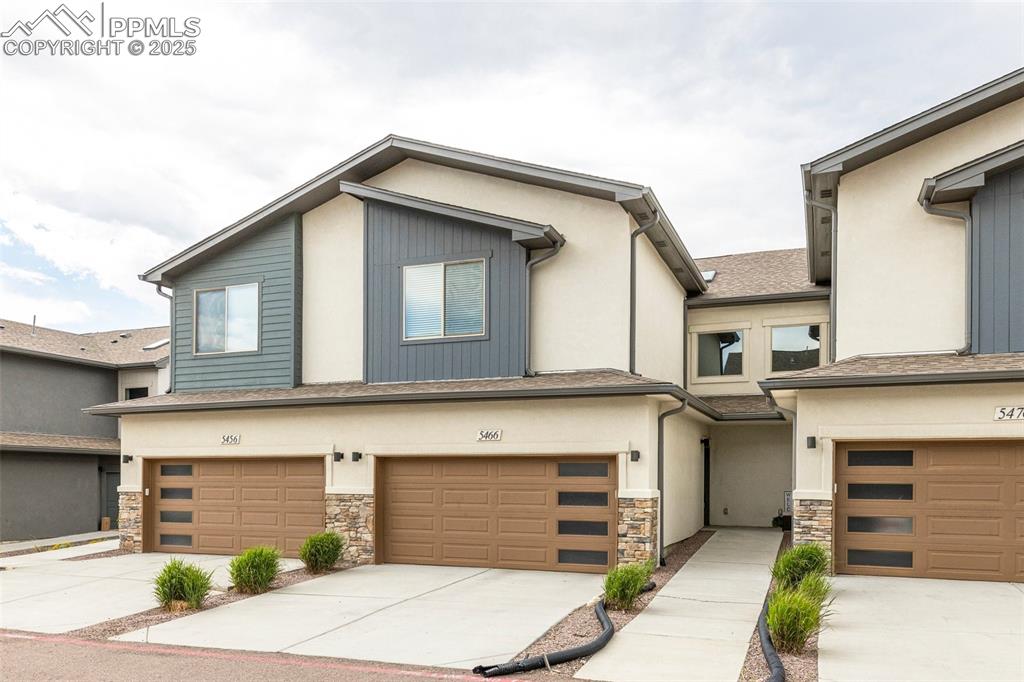 5466 Arden Grove Colorado Springs, CO 80922 - Photo 1 of 35 a front view of a house with a garage