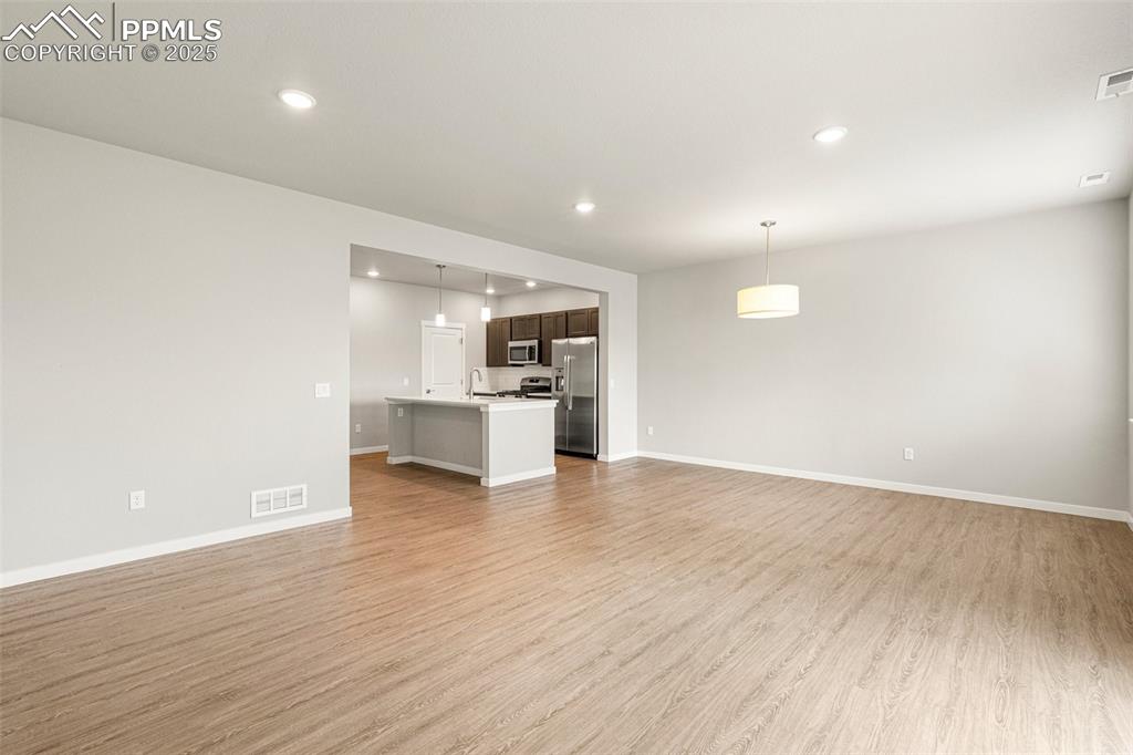 5466 Arden Grove Colorado Springs, CO 80922 - Photo 16 of 35 a view of kitchen dining space with wooden floor