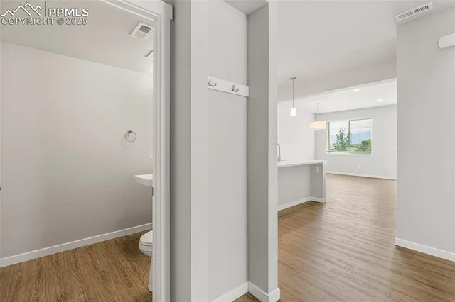 a view of hallway with wooden floor