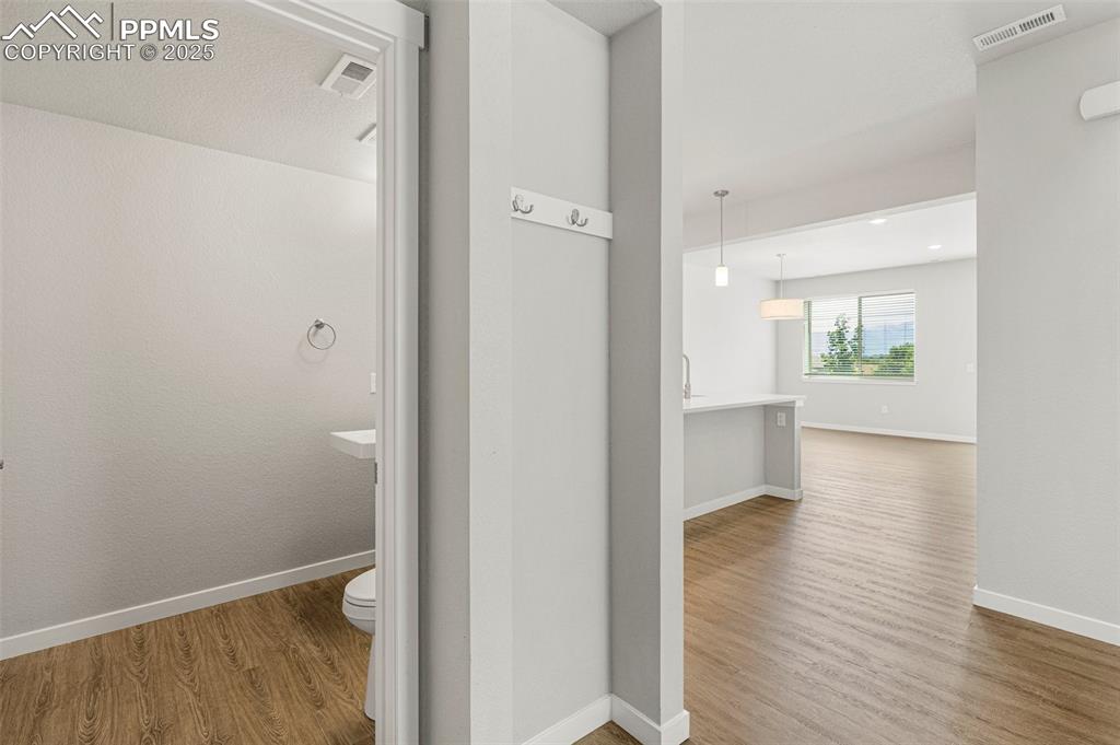 5466 Arden Grove Colorado Springs, CO 80922 - Photo 18 of 35 a view of hallway with wooden floor