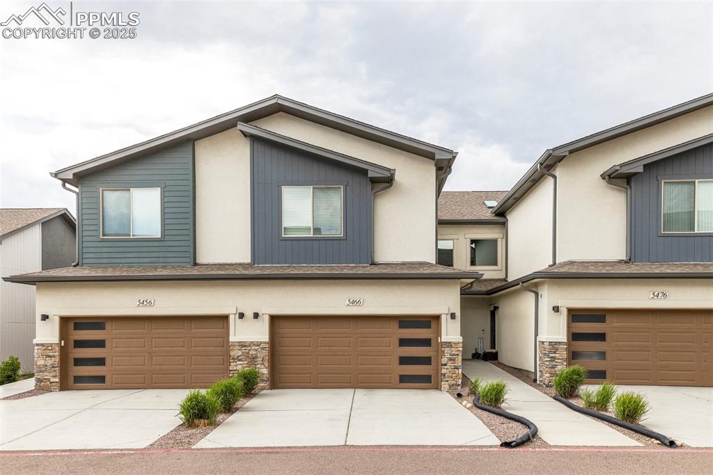 5466 Arden Grove Colorado Springs, CO 80922 - Photo 2 of 35 a front view of a house with garage