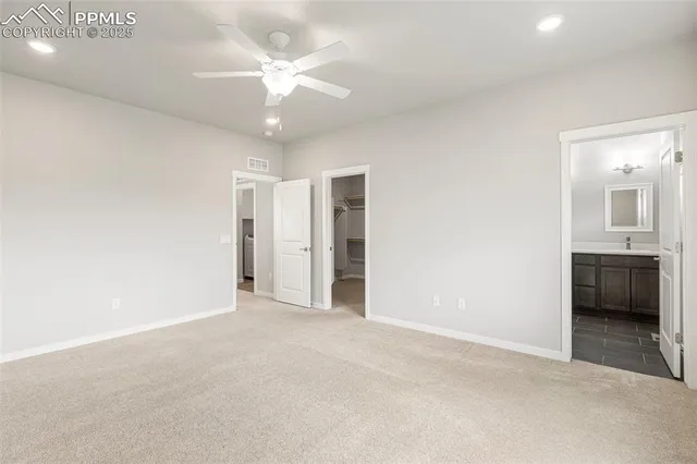 an empty room with a bathroom and a sink
