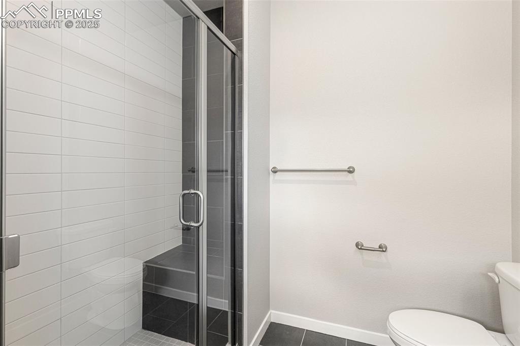 5466 Arden Grove Colorado Springs, CO 80922 - Photo 26 of 35 a bathroom with a toilet and shower