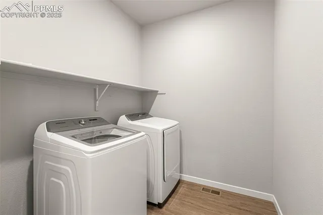 a view of an entryway with wooden floor