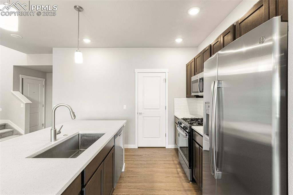 5466 Arden Grove Colorado Springs, CO 80922 - Photo 7 of 35 a kitchen with a refrigerator sink and cabinets