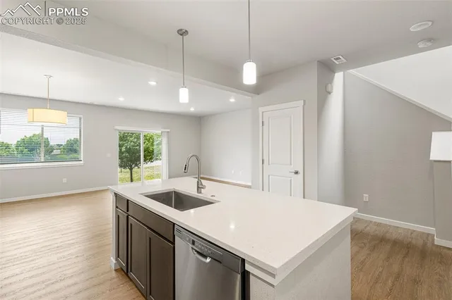 a kitchen with a stove a sink and a large window