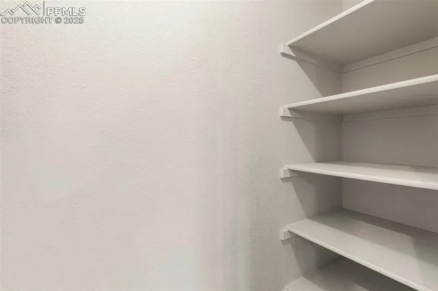 a white toilet sitting next to a white cabinet