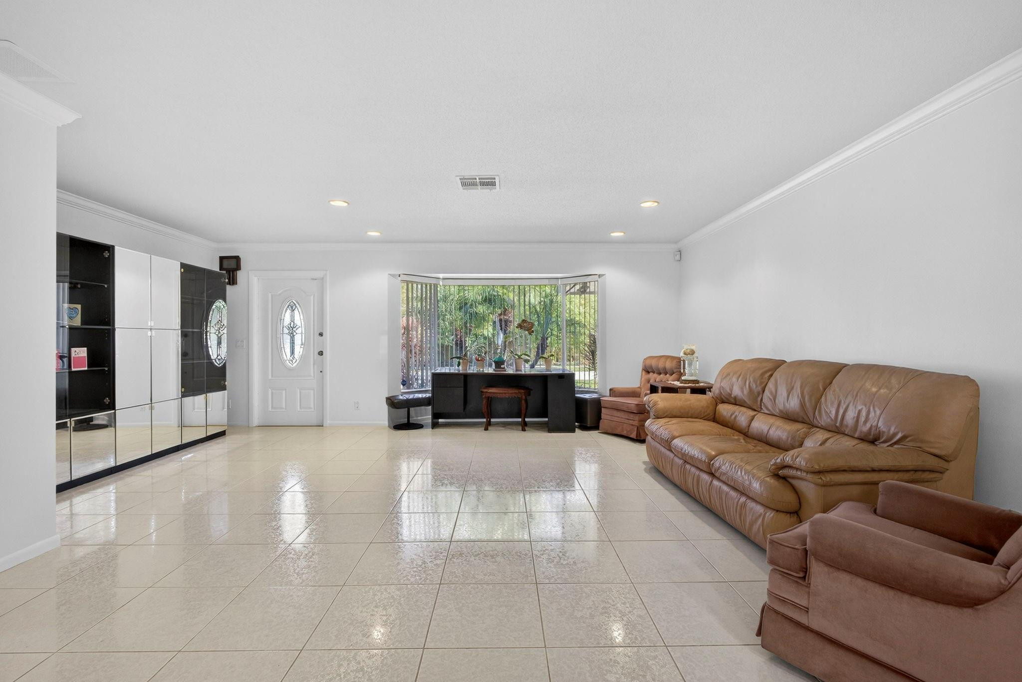 12753 Longford Road North Palm Beach, FL 33408 - Photo 19 of 68 a living room with furniture and window
