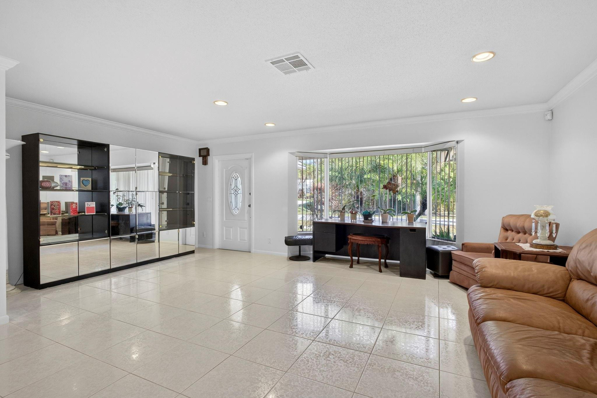 12753 Longford Road North Palm Beach, FL 33408 - Photo 20 of 68 a living room with furniture and a large window