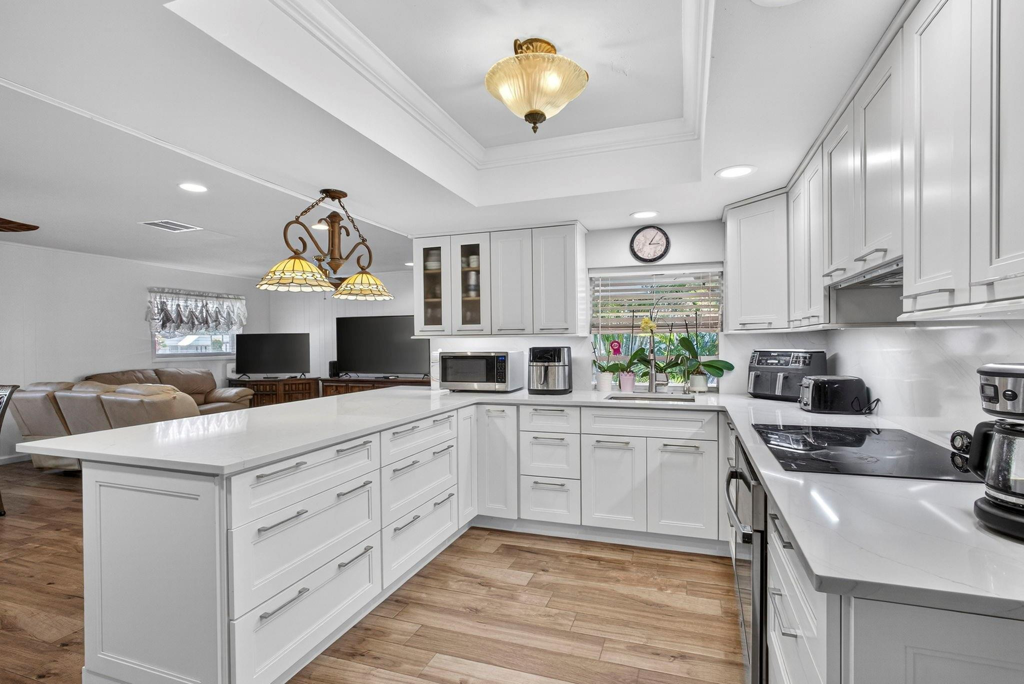 12753 Longford Road North Palm Beach, FL 33408 - Photo 23 of 68 a kitchen with a stove a sink and a refrigerator
