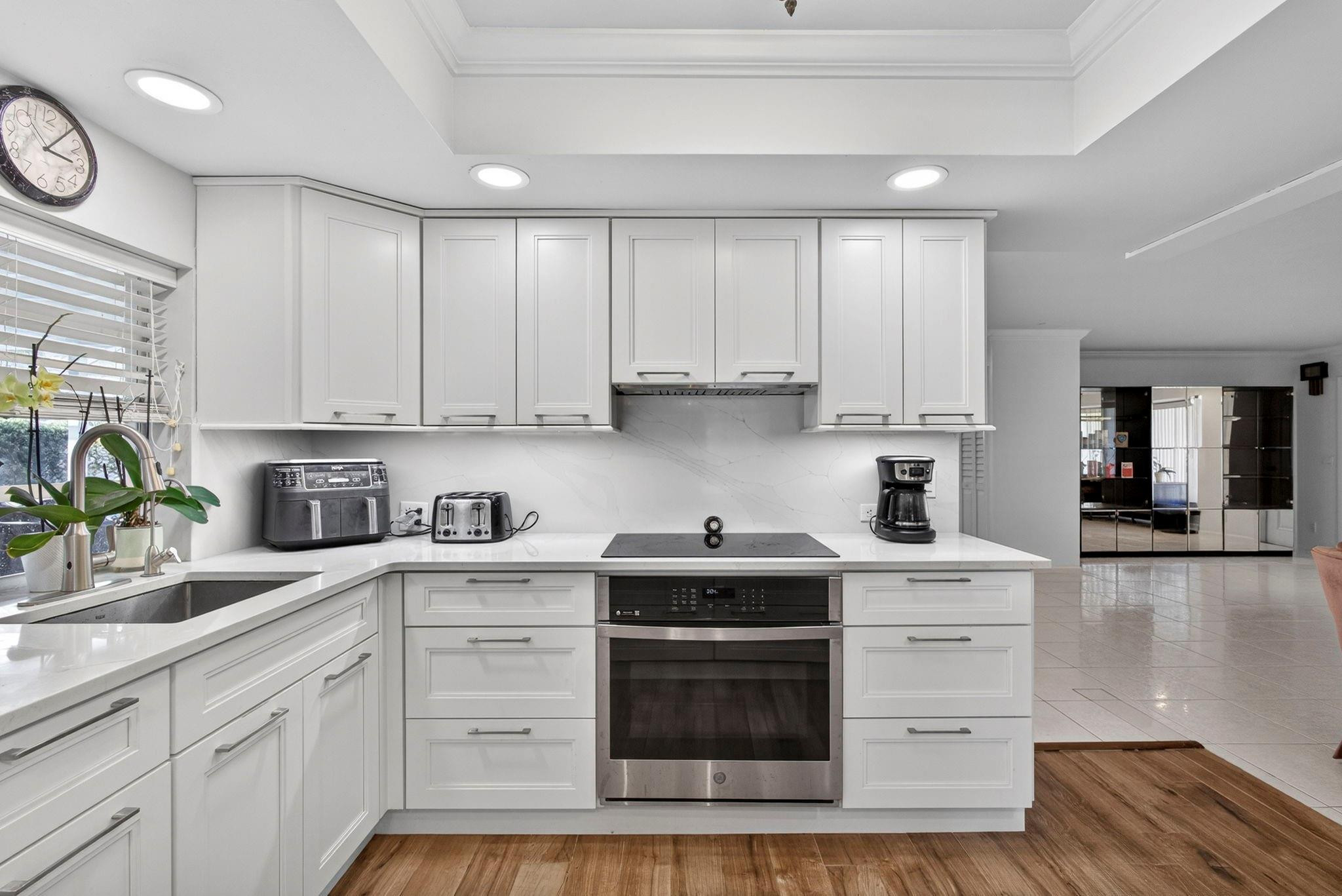 12753 Longford Road North Palm Beach, FL 33408 - Photo 26 of 68 a kitchen with stainless steel appliances granite countertop a sink a stove and cabinets