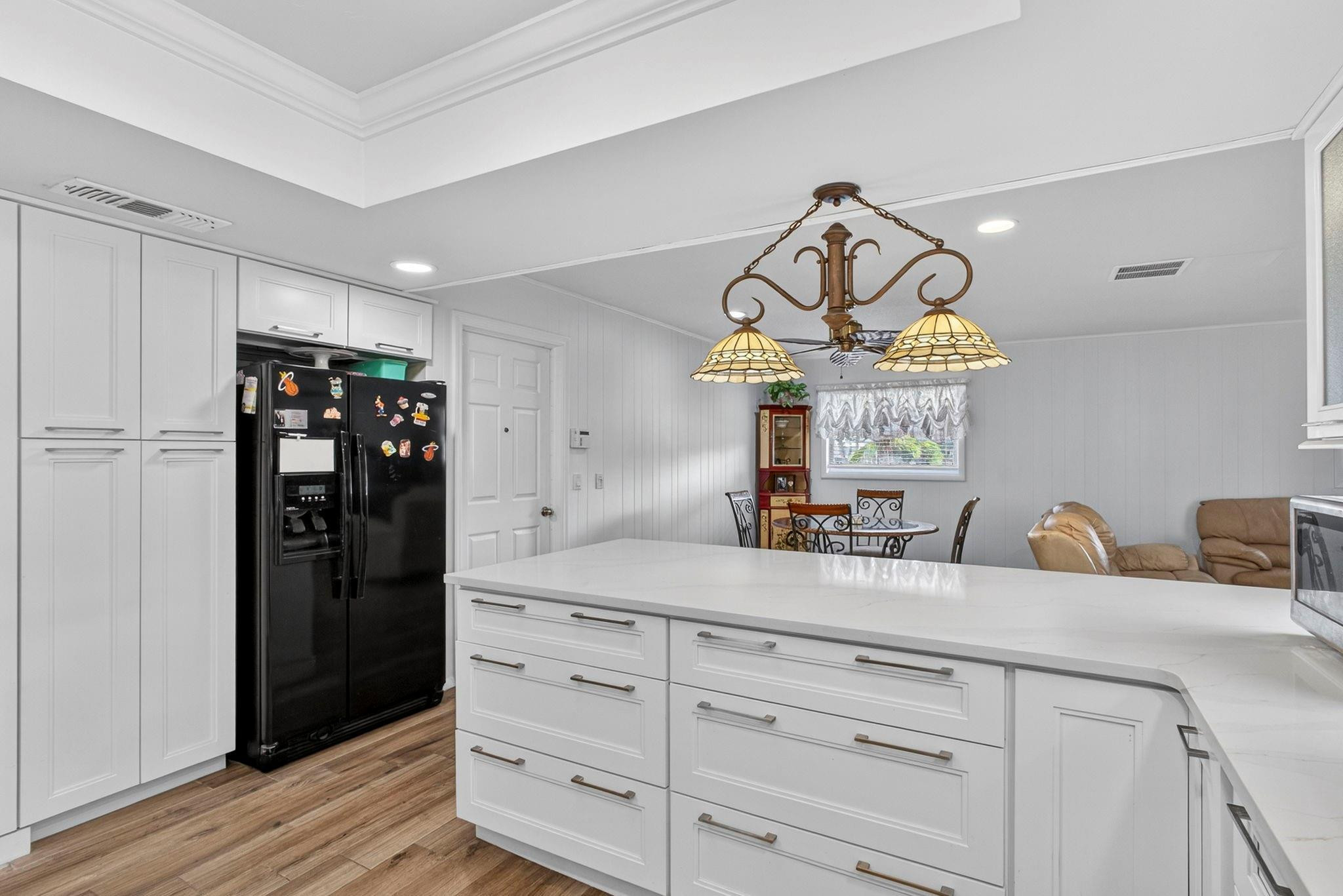 12753 Longford Road North Palm Beach, FL 33408 - Photo 28 of 68 a kitchen with refrigerator and cabinets