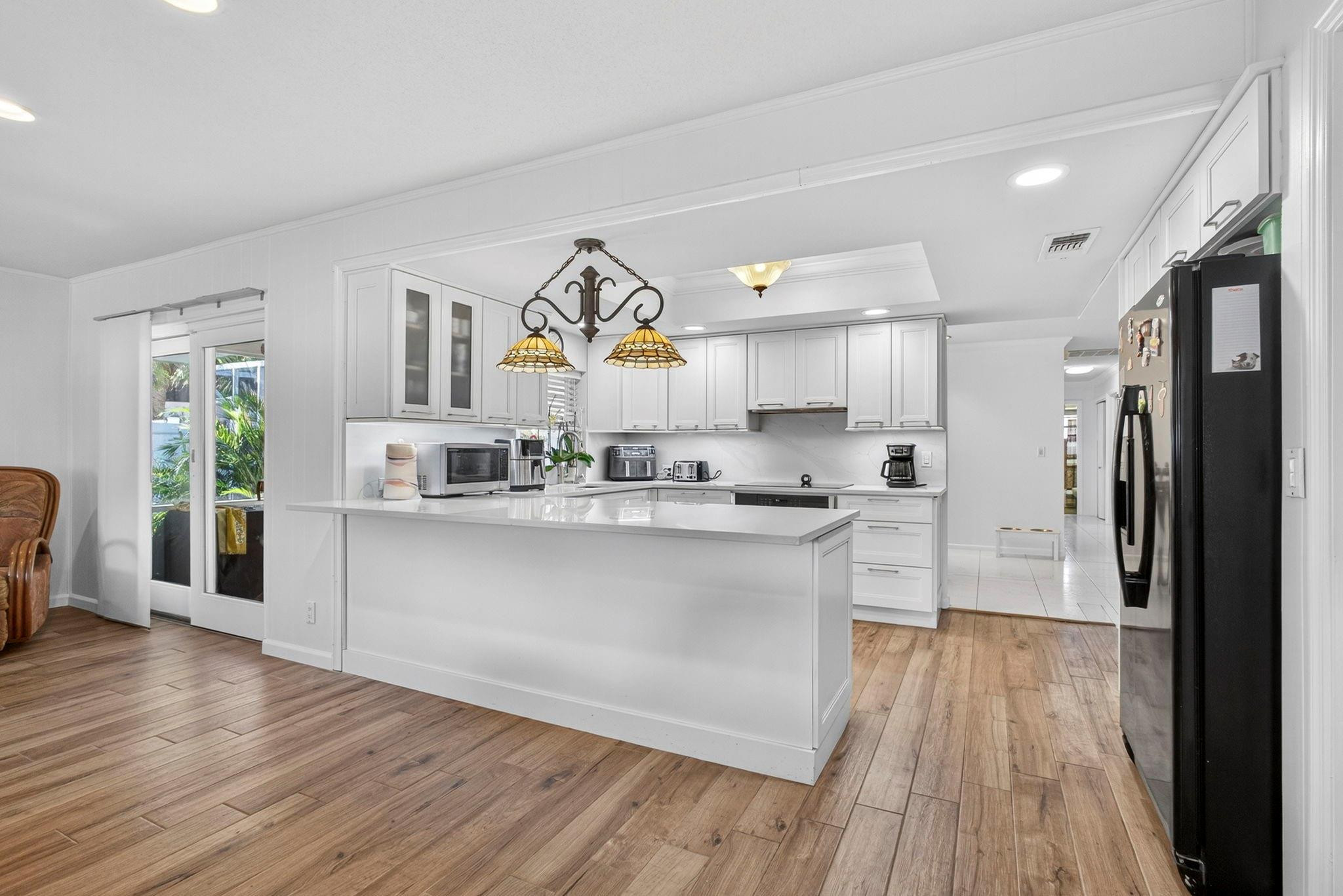 12753 Longford Road North Palm Beach, FL 33408 - Photo 29 of 68 a kitchen with stainless steel appliances a lot of counter top space and furniture