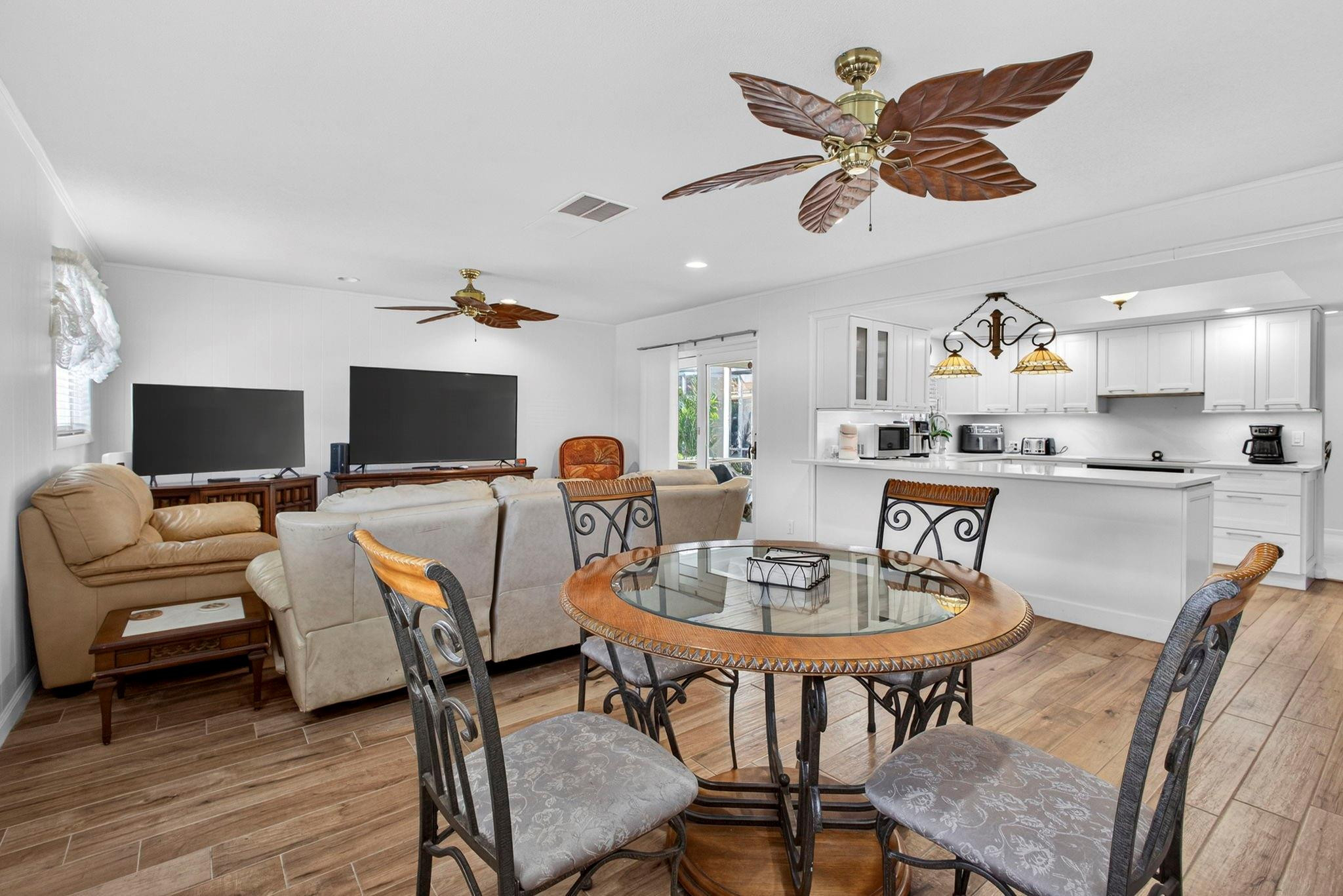 12753 Longford Road North Palm Beach, FL 33408 - Photo 30 of 68 a living room with furniture kitchen view and a flat screen tv