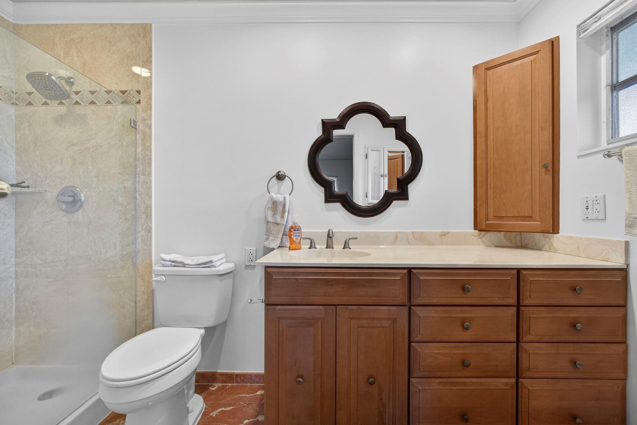 12753 Longford Road North Palm Beach, FL 33408 - Photo 39 of 68 a bathroom with a granite countertop toilet sink and mirror