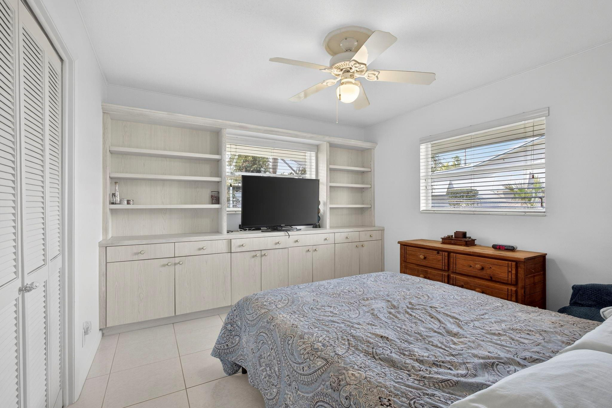 12753 Longford Road North Palm Beach, FL 33408 - Photo 41 of 68 a bedroom with a bed and a television