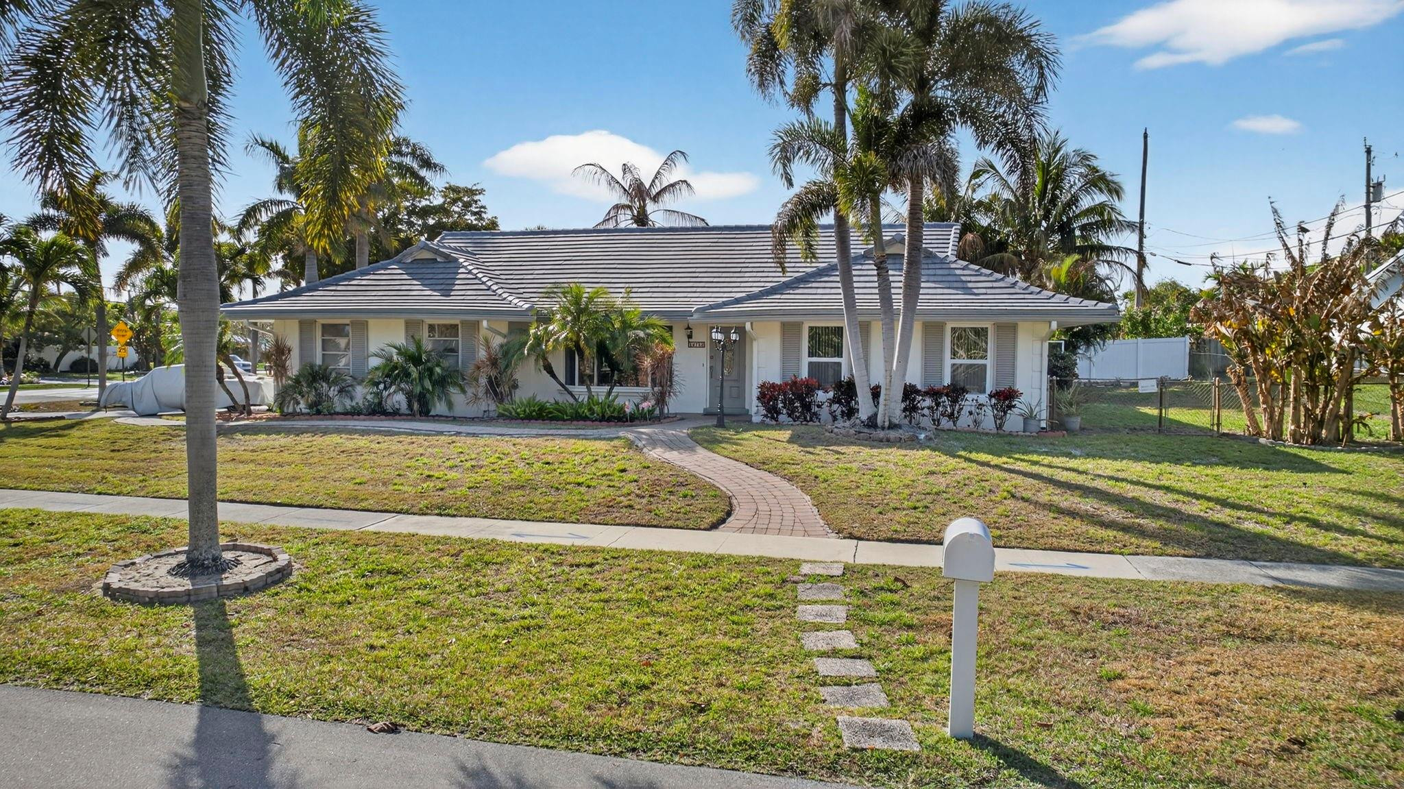 12753 Longford Road North Palm Beach, FL 33408 - Photo 10 of 68 a view of a house with swimming pool yard and outdoor seating