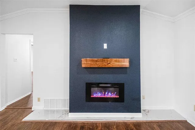 a view of fireplace with wooden floor