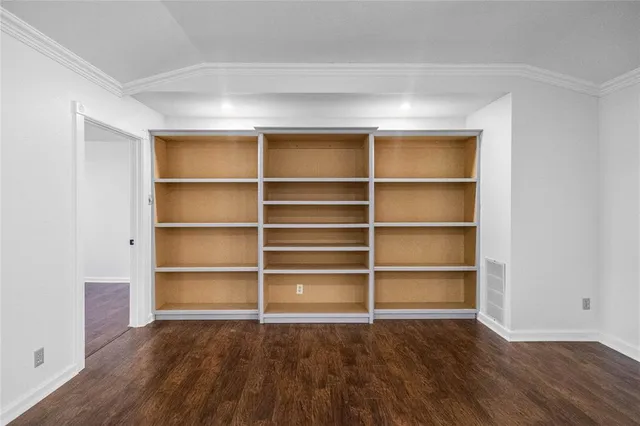 a view of a room with wooden floor and a window
