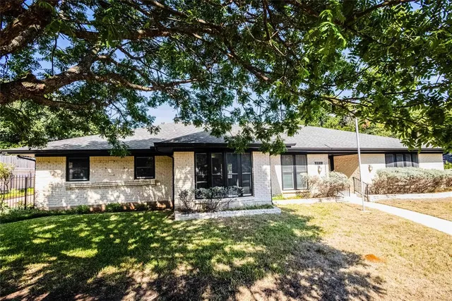 a front view of a house with yard