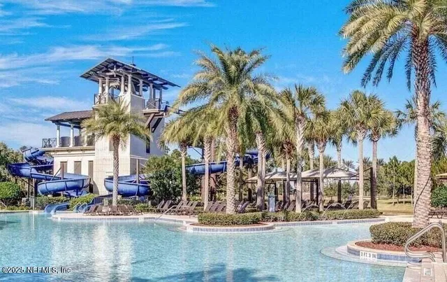 a white bath tub sitting in a bathroom next to a window
