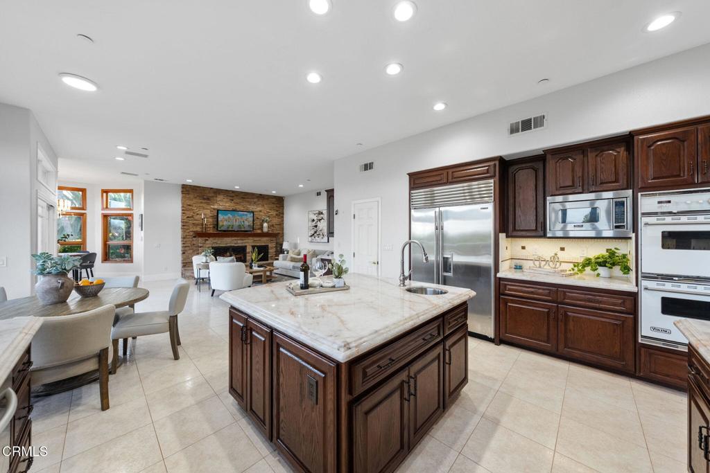 43650 Camaron Road Temecula, CA 92590 - Photo 14 of 52 a kitchen with stainless steel appliances granite countertop a stove and a refrigerator