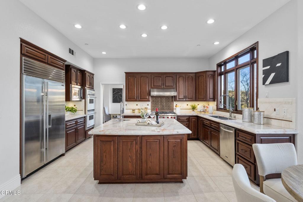 43650 Camaron Road Temecula, CA 92590 - Photo 15 of 52 a kitchen with stainless steel appliances granite countertop a sink stove and refrigerator