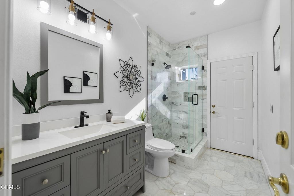 43650 Camaron Road Temecula, CA 92590 - Photo 22 of 52 a bathroom with a double vanity sink toilet and shower