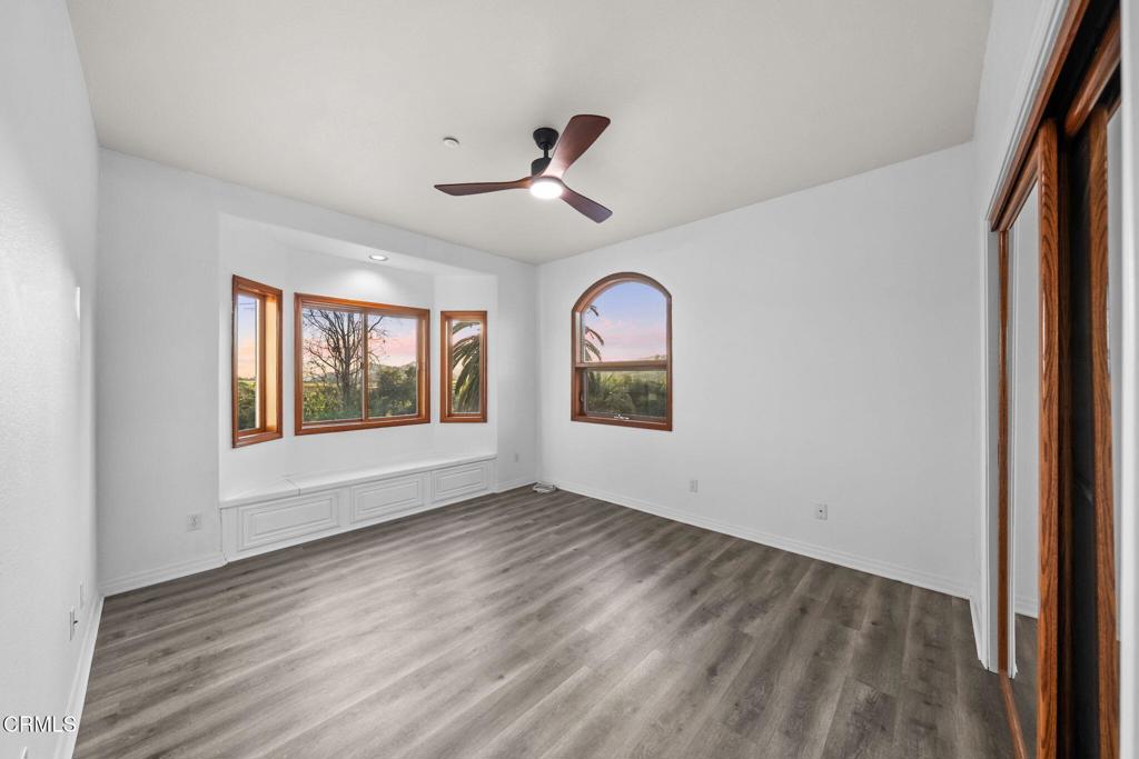 43650 Camaron Road Temecula, CA 92590 - Photo 28 of 52 an empty room with wooden floor fan and windows