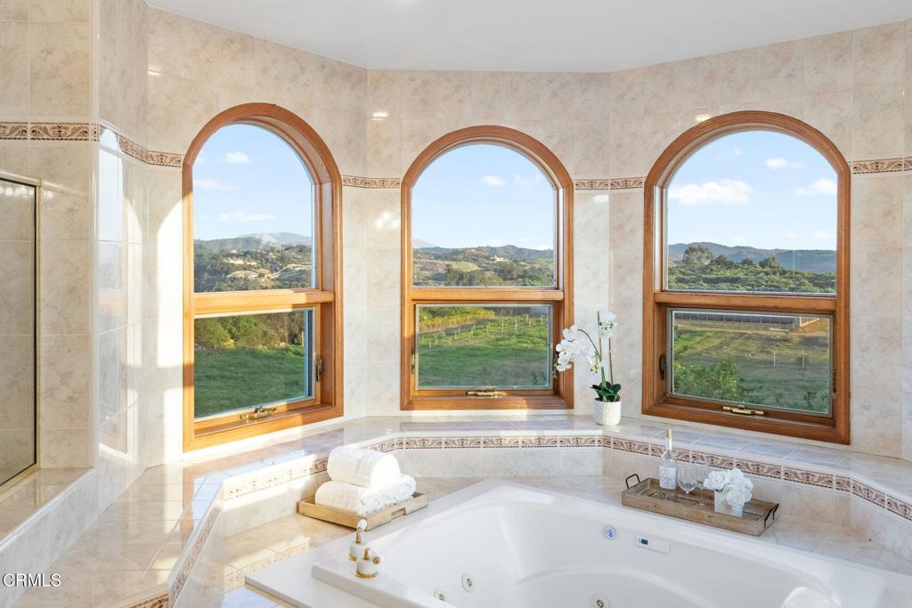 43650 Camaron Road Temecula, CA 92590 - Photo 40 of 52 a bathroom with a tub a window and a sink