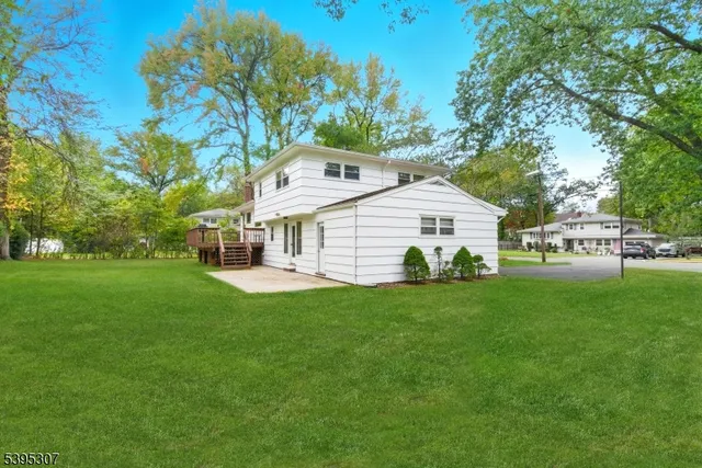 a front view of a house with a yard and trees