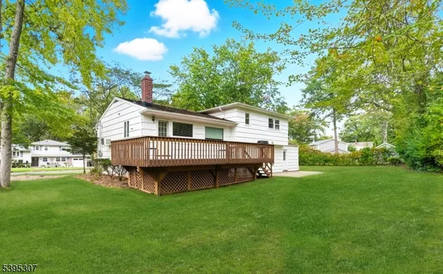 a view of a house with a backyard and a patio