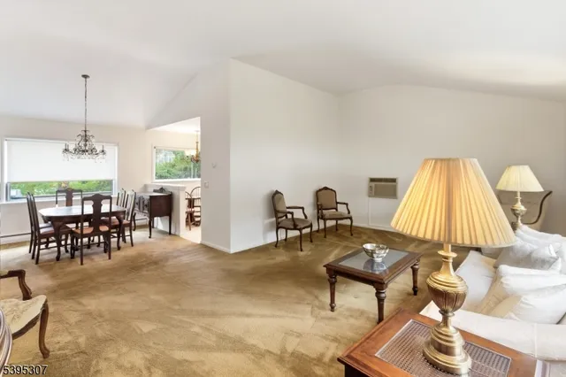 a living room with furniture a window and a dining table