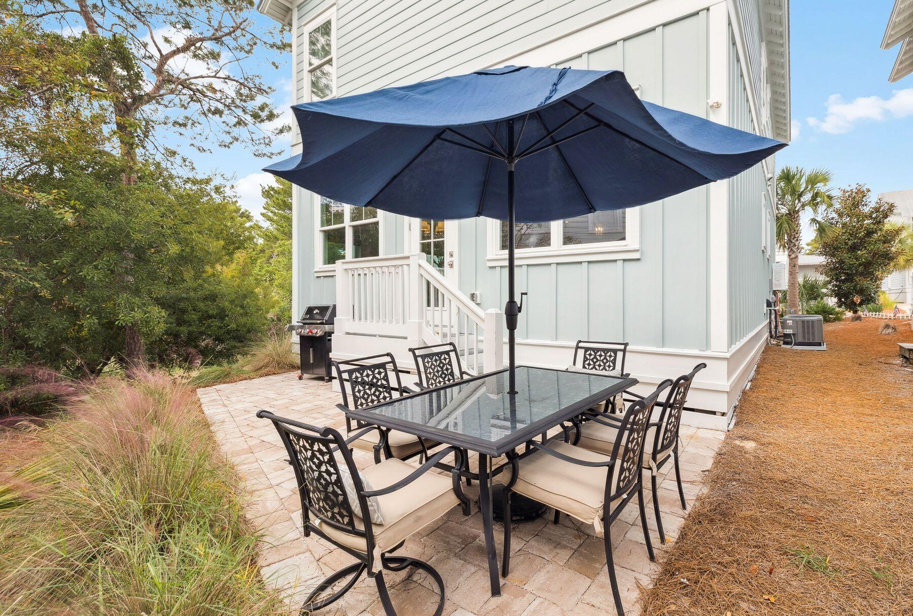 421 Gulfview Circle Santa Rosa Beach, FL 32459 - Photo 25 of 34 a patio table and chairs under an umbrella