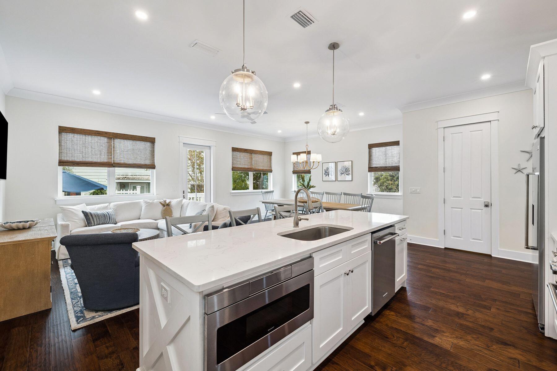 421 Gulfview Circle Santa Rosa Beach, FL 32459 - Photo 8 of 34 a view of a kitchen counter space wooden floor and a chandelier
