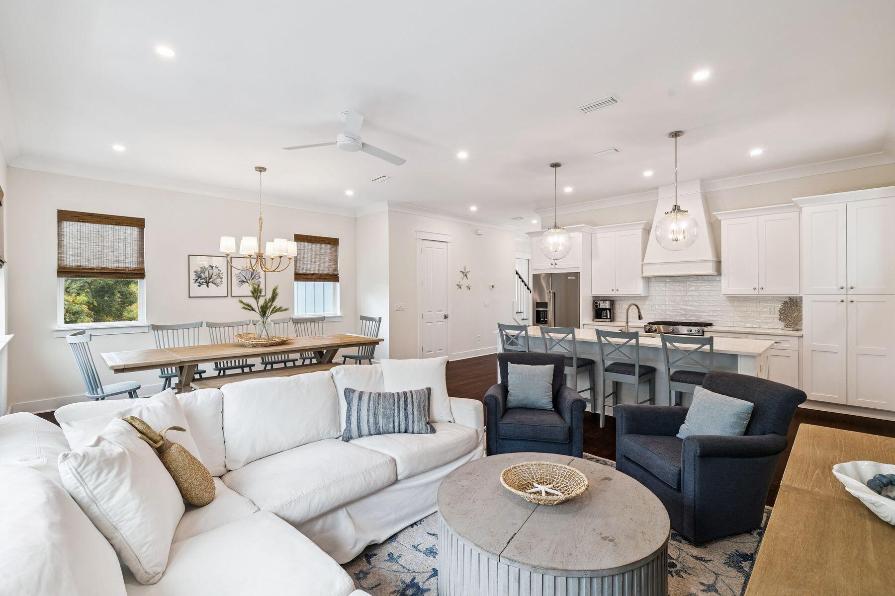 421 Gulfview Circle Santa Rosa Beach, FL 32459 - Photo 10 of 34 a living room with stainless steel appliances kitchen island granite countertop a stove a sink a dining table and chairs