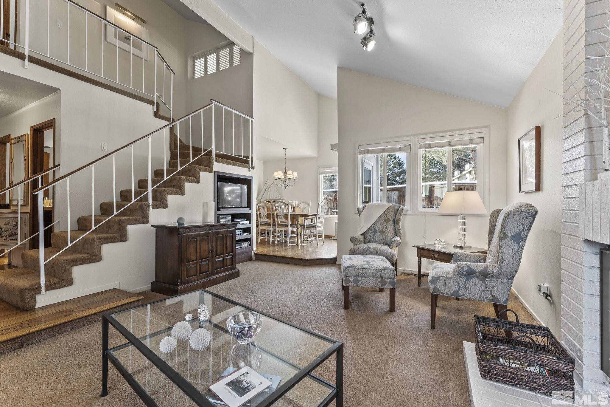 4303 Clyde Court Reno, NV 89509 - Photo 4 of 40 a living room with furniture stairs and a large window