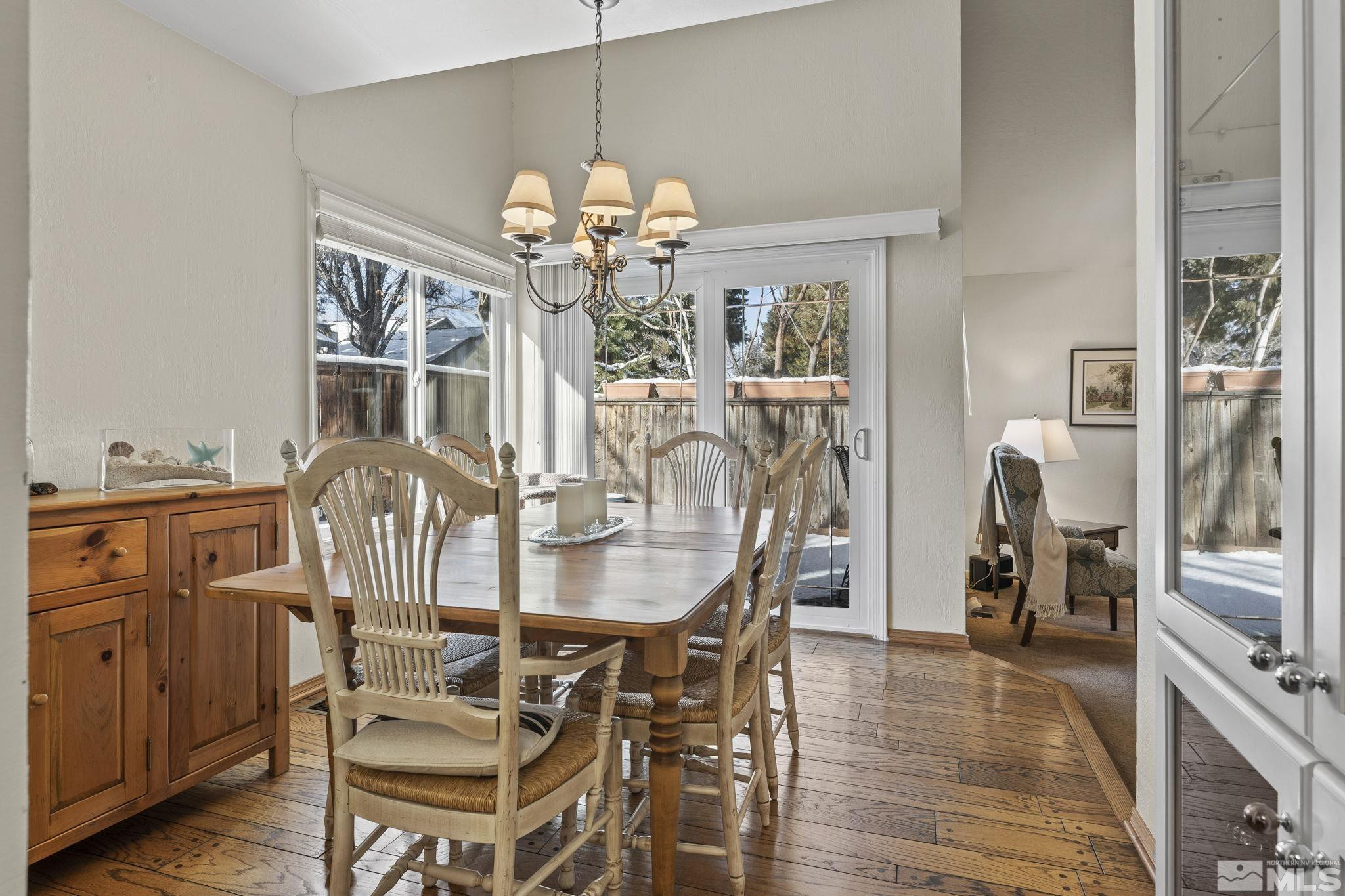 4303 Clyde Court Reno, NV 89509 - Photo 8 of 40 a view of a dining room with furniture a chandelier and wooden floor