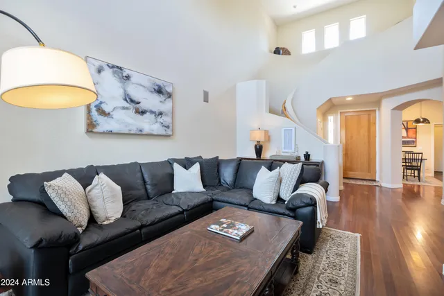 a living room with furniture and a painting on the wall
