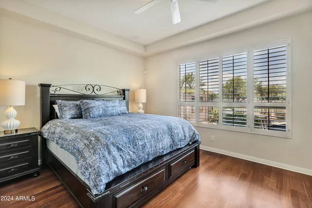 a bed sitting in a bedroom next to a window